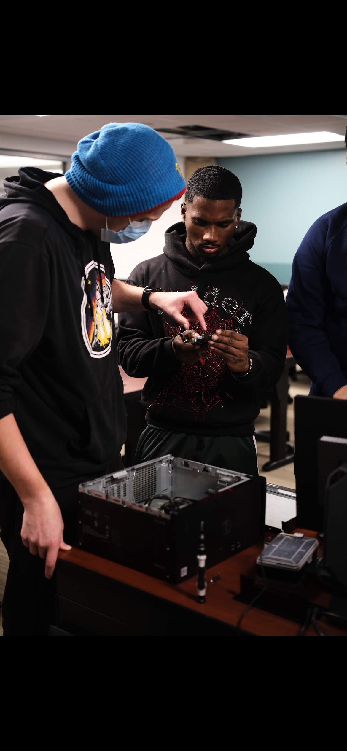 Students examining a computer component